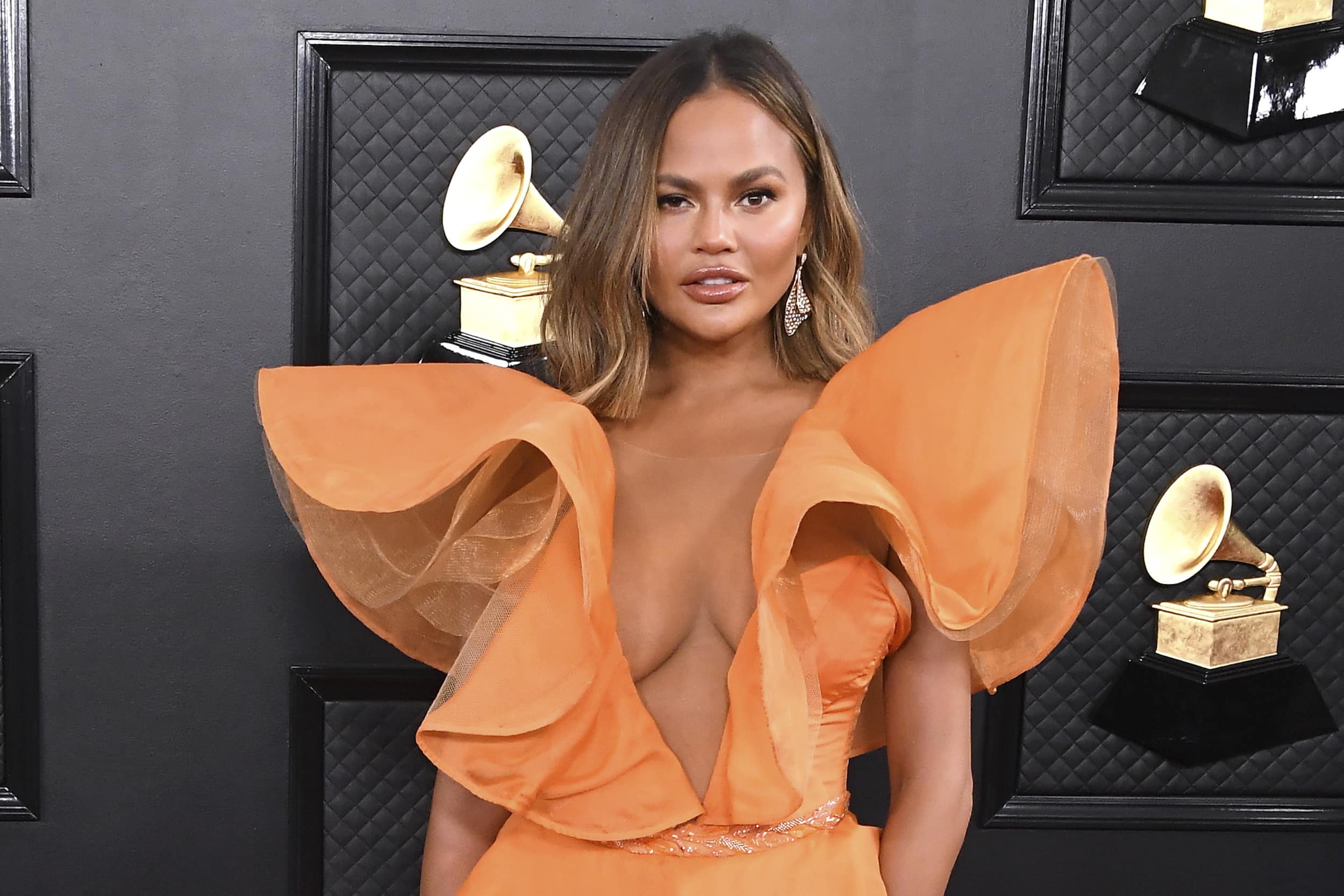 Chrissy Teigen 'getting her boobs out' as she heads for surgery